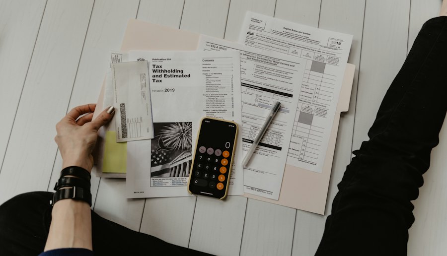 Tax forms with a calculator and pen